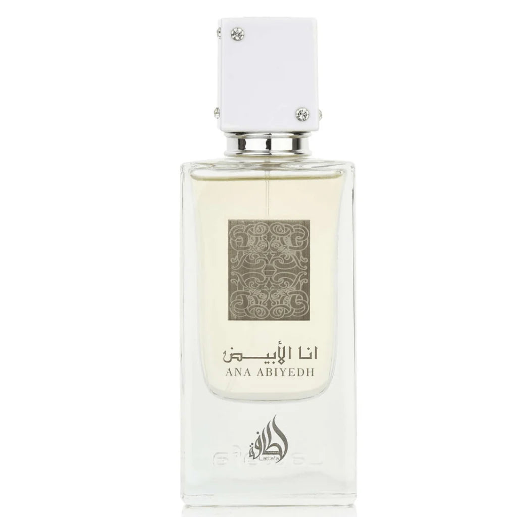 A clear rectangular bottle of Ana Abiyedh Eau de Parfum by Ard Al Zaafaran Lattafa Perfumes. The bottle features a minimalist design with a white cap adorned with small silver accents. The front of the bottle displays intricate silver patterns along with the fragrance name "Ana Abiyedh" in both Arabic and English.