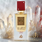 Lattafa Ana Abiyedh Rouge perfume bottle featuring a red cap, centered among clear quartz crystals.