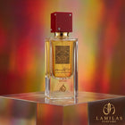 Ana Abiyedh Rouge perfume bottle by Lamilas, featuring a clear rectangular design and a square dark red studded cap, displayed on a chrome cube.