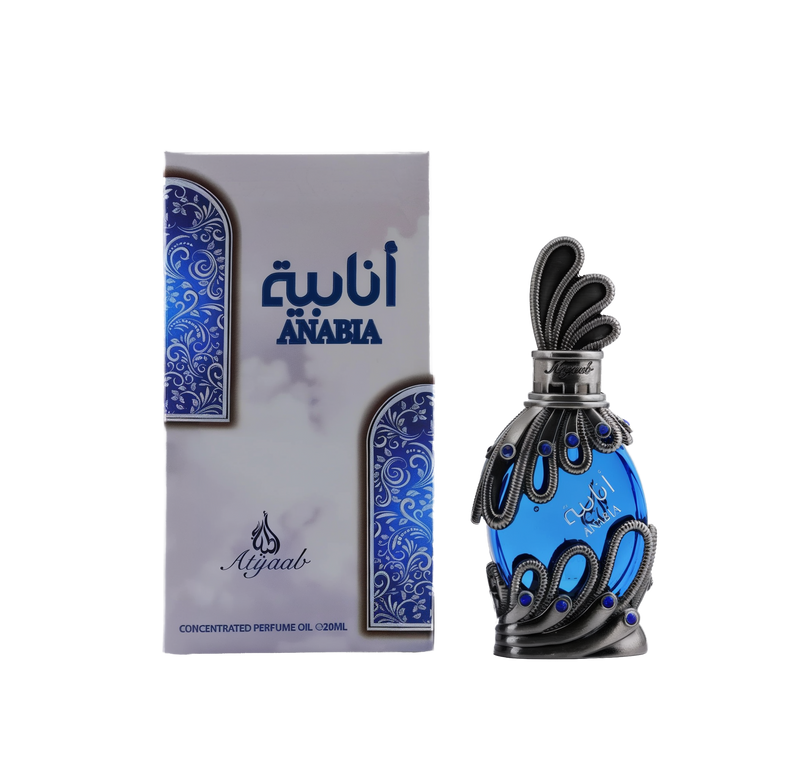 A vivid blue glass bottle of Anabia concentrated perfume oil by Khadlaj encased in an ornate silver filigree design with small blue accents and topped with a sculpted silver cap, shown alongside its matching box decorated with swirls in complementary shades of blue and silver.