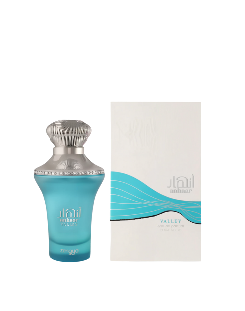 A bottle and packaging of Anhaar Valley Eau De Parfum by Zimaya. The perfume bottle is a sleek, curvy design in frosted aqua blue glass, topped with a detailed metallic silver cap and rim. The front displays the name "Anhaar Valley" in elegant white text with the Zimaya logo. The box is white with a minimalist wave graphic in turquoise and silver, reinforcing the fragrance's fresh, aquatic theme.