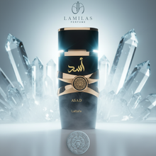 Black and gold Lattafa Asad perfume bottle with Arabic script, standing among large, icy quartz crystals.lattafa-asad-black-gold-perfume-crystal.jpg