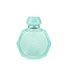 A pastel blue octagonal perfume bottle with intricate embossed designs on the front. The bottle features a matching pastel blue cap and a silver collar, adding a touch of elegance and sophistication. The soft blue color and detailed patterns give the bottle a delicate and luxurious appearance, perfect for a high-end fragrance.