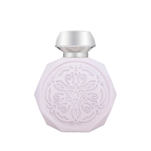 A pale pink, octagonal perfume bottle with intricate, embossed designs on the front. The bottle features a sleek, metallic silver cap that contrasts with the delicate design. The detailed pattern on the bottle adds an elegant and sophisticated touch to its overall appearance.