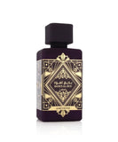 The image features a sophisticated perfume bottle of "Bade'e Al Oud Amethyst" by Lattafa. The bottle has a solid, dark purple hue that exudes luxury and depth. It's square in shape with a flat, wide body and a modest, dark purple cap. The front of the bottle is adorned with intricate golden geometric patterns and Arabic calligraphy, emphasizing the brand's rich cultural heritage.