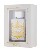 This image displays a perfume package with a white rectangular box that has a window showing the bottle inside. The box is labeled "HONOR & GLORY Lattafa" at the top, with intricate gold geometric and floral designs around the window and on the lower part