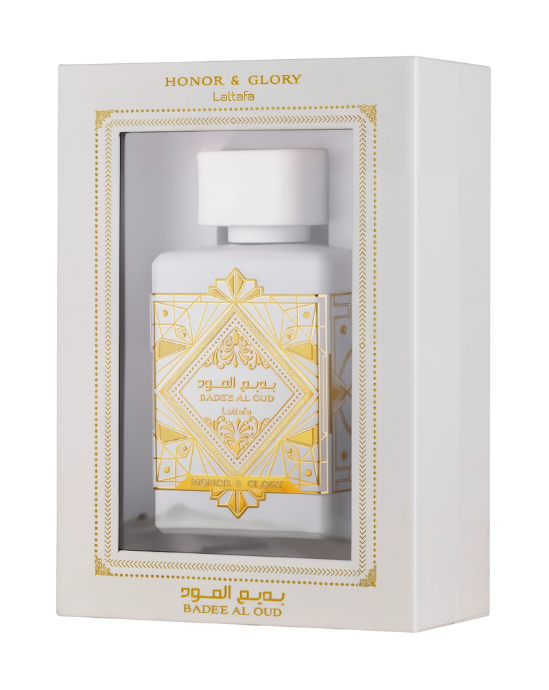 This image displays a perfume package with a white rectangular box that has a window showing the bottle inside. The box is labeled "HONOR & GLORY Lattafa" at the top, with intricate gold geometric and floral designs around the window and on the lower part