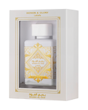 This image displays a perfume package with a white rectangular box that has a window showing the bottle inside. The box is labeled "HONOR & GLORY Lattafa" at the top, with intricate gold geometric and floral designs around the window and on the lower part