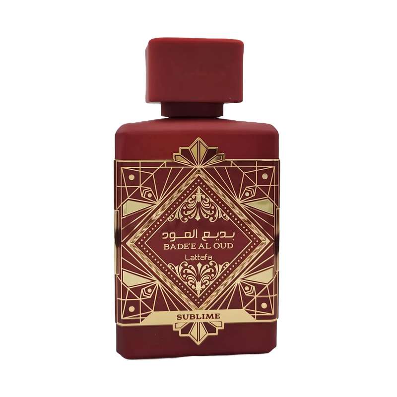 This image shows a deep burgundy perfume bottle with the name "BADEE AL OUD SUBLIME" from the brand Lattafa. The bottle has a matte finish with a matching square cap. It features a luxurious gold geometric pattern with traditional motifs, and the name is written in both Arabic and English. The word "SUBLIME" is displayed on a gold banner at the base. The design conveys a sense of rich heritage and sophistication.
