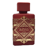 This image shows a deep burgundy perfume bottle with the name "BADEE AL OUD SUBLIME" from the brand Lattafa. The bottle has a matte finish with a matching square cap. It features a luxurious gold geometric pattern with traditional motifs, and the name is written in both Arabic and English. The word "SUBLIME" is displayed on a gold banner at the base. The design conveys a sense of rich heritage and sophistication.