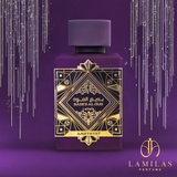 Purple Bade’e Al Oud Amethyst perfume bottle with gold label against sparkling backdrop.