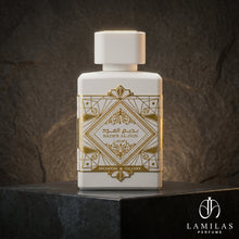 Lattafa Bade'e Al Oud Honor and Glory white perfume bottle featuring an intricate gold geometric design, displayed on black stone.