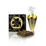 This image features a product called "Bakhoor Irth" from the Master Perfumer Collection by Nabeel Perfumes. On the left is a black packaging box with golden designs depicting palm trees, camels, and traditional Arabian imagery, with the product name prominently displayed. On the right, there's a golden bakhoor burner with intricate patterns, emitting wisps of smoke, indicating that the bakhoor is being used.