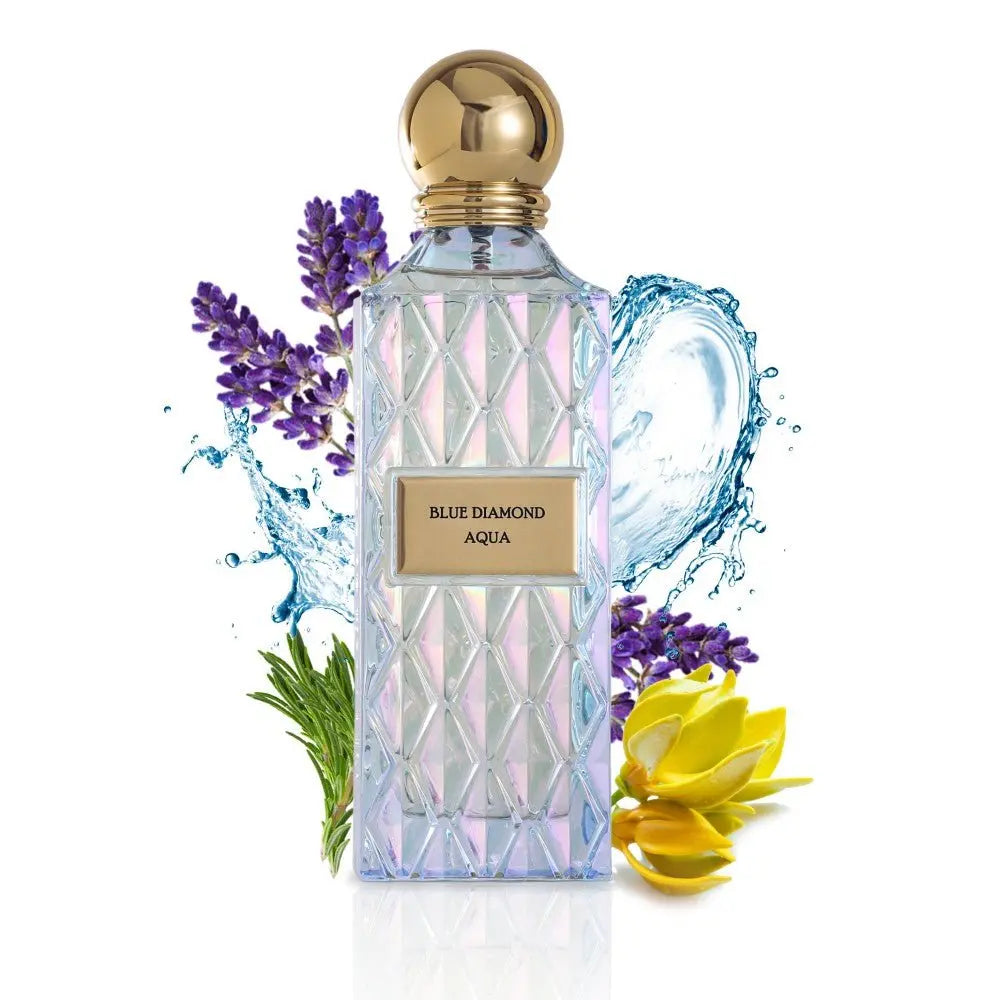 The image shows a clear, faceted glass perfume bottle with a gold cap and a label that reads "BLUE DIAMOND AQUA." The bottle is surrounded by visual elements that evoke the scent's character: sprigs of purple lavender on the left, splashing water droplets around the bottle, and yellow ylang-ylang flowers on the right. The overall presentation suggests a fresh, aquatic, and floral fragrance, with a luxurious and clean aesthetic emphasized by the white background.