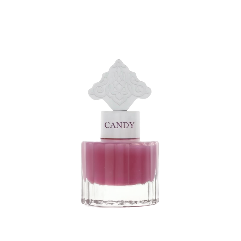  The image features a perfume bottle with a clear base and a purple-colored liquid. It has a white cap with the word "CANDY" printed on it in purple, matching the liquid's color. The cap is topped with a white ornate design that resembles an intricate architectural pattern, possibly inspired by Middle Eastern art.
