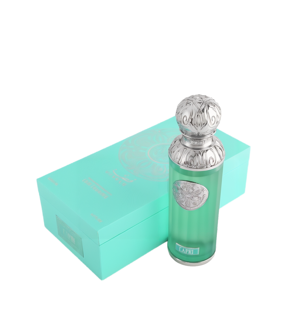 The image shows a perfume bottle named "Capri" from the Gissah collection, placed next to its packaging. The perfume bottle is cylindrical with a teal glass body and a decorative silver cap featuring intricate embossed patterns. A silver medallion with an ornate design is affixed to the front of the bottle. The packaging is a matching teal box with a mandala-like design and the names "Gissah" and "Capri" printed on it.