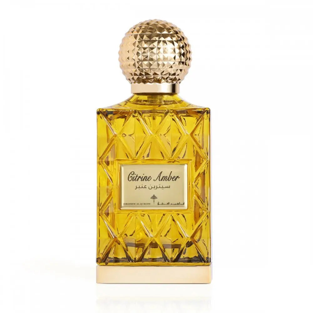 The image displays a perfume bottle with a golden yellow liquid, named "Citrine Amber." The design features a faceted glass structure with a textured gold cap, and the label includes the name in English and Arabic script. The bottle's design gives off a luxurious and classic vibe, and the color of the perfume suggests a warm, amber-based scent.