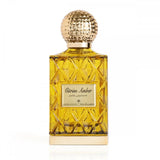 The image displays a perfume bottle with a golden yellow liquid, named "Citrine Amber." The design features a faceted glass structure with a textured gold cap, and the label includes the name in English and Arabic script. The bottle's design gives off a luxurious and classic vibe, and the color of the perfume suggests a warm, amber-based scent.