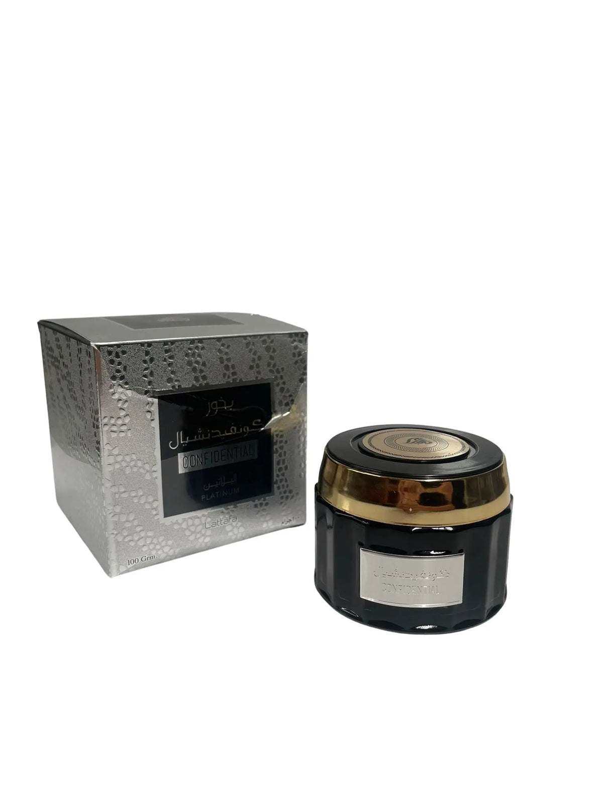 The image displays a product called "Confidential Platinum" by Lattafa, which appears to be a container of bakhoor, a type of scented bricks or powder used in the Middle East to perfume the home and clothing. The jar is black with a gold trim and label, and there is a matching box in the background with a silver and black design. The label on the box is partially visible and includes both Arabic and English text, indicating the dual-language branding.