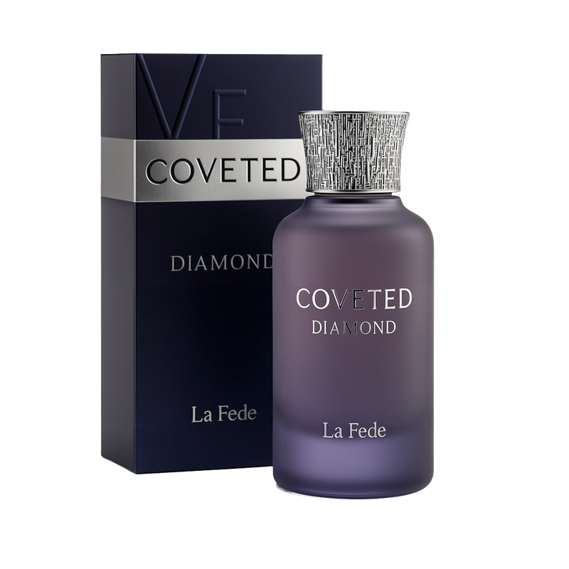 A bottle and packaging of Coveted Diamond Eau De Parfum by La Fede. The perfume bottle is matte purple with a gradient effect, featuring silver embossed text reading "COVETED DIAMOND" and "La Fede." It has a textured silver cap with a modern, intricate pattern. The box beside it is dark navy with silver accents, matching the bottle's design, and prominently displays the product name and brand.