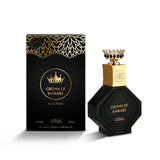 The image shows a luxurious perfume set titled "Crown of Emirates" by Nabeel Perfumes. It includes a black hexagonal bottle with a textured design around the label, which is inscribed with the perfume's name in gold lettering. The cap is a striking gold color, surmounted by a detailed crown with black and gold accents, emphasizing the regal theme.