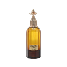 The image shows a bottle of "CRYSTA OUD" by Zimaya, a luxury fragrance. The bottle is tall with a rectangular base and rounded shoulders, filled with a rich amber-colored liquid. It features a thick, dark brown base that lightens as it reaches the top. The cap is a distinctive spray nozzle with a textured ring and an ornate, gold-toned decorative element on top that looks like a stylized flower. 