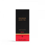 The image depicts the packaging of "Diva Darling" perfume from the Rouge Collection by Ibraheem Al Qurashi. The box is predominantly black with gold text featuring the perfume's name and the Arabic translation above it. A red band at the bottom of the box includes the reference number "R214" in white text, along with the brand's logo in gold.