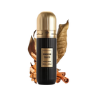 A cylindrical black perfume bottle with a gold cap, labeled "DOMINICAN TOBACCO" in white text, and "Extrait de Parfum 100 ml 3.4 fl.oz" in smaller white text. It has an Arabic inscription and the brand name "IBRAHEEM AL QURASHI" at the top. The bottle is presented in front of two large dried tobacco leaves and rests on a surface with scattered cinnamon sticks. The background is white, emphasizing the product.