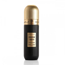 A black perfume bottle with vertical ridges and a gold cap. The bottle has a gold label with "DOMINICAN TOBACCO" in bold letters and "Extrait de Parfum 100 ml 3.4 fl.oz" below in smaller font. Above the label, there is Arabic calligraphy and the brand name "IBRAHEEM AL QURASHI" in English. The bottle is placed against a white background, highlighting its design and contents.