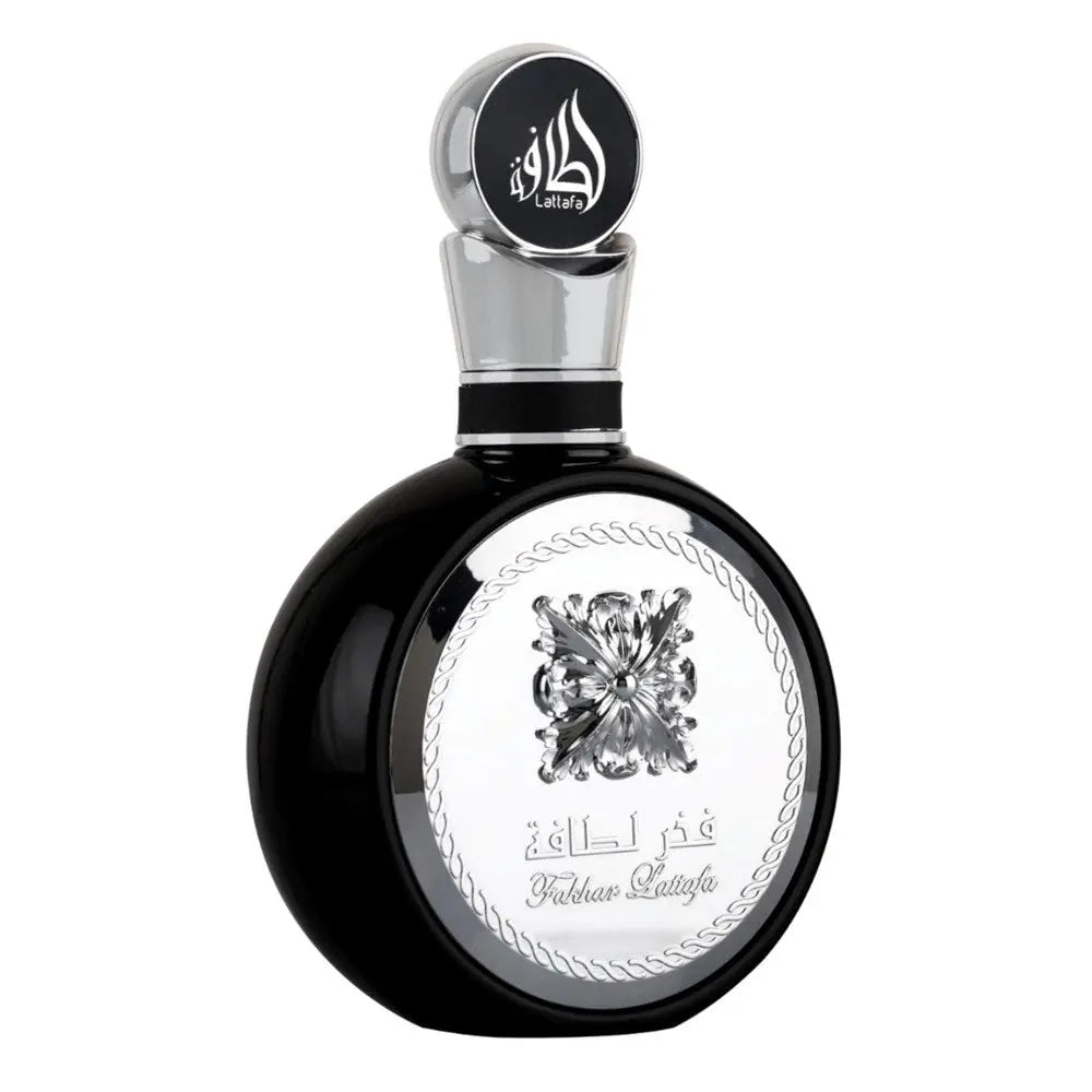 A sleek black perfume bottle with a silver cap and intricate detailing. The cap is adorned with stylized Arabic calligraphy that reads "Lattafa." The central part of the bottle features a silver emblem of an ornate flower, encircled by a rope-like border with the text "Fakhar Lattafa" beneath it. The design elements give the product a luxurious and masculine appeal.