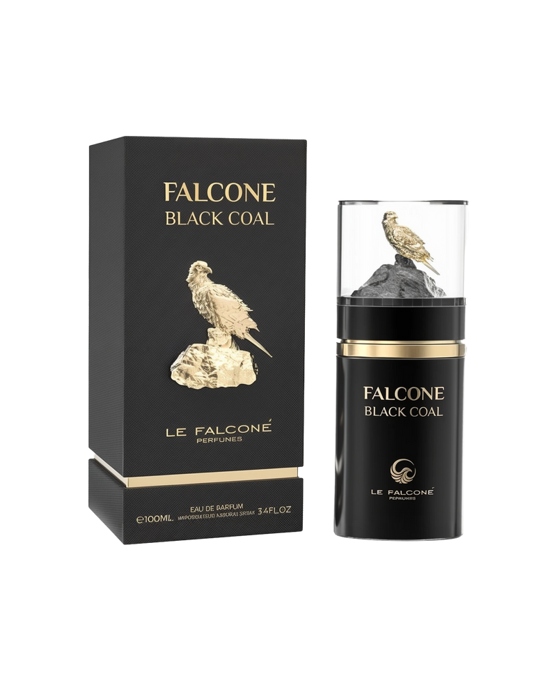 A black rectangular perfume box labeled ‘Falcone Black Coal’ by Le Falcone stands beside a matching cylindrical black bottle with a clear cap showcasing a gold falcon perched on a dark rock.