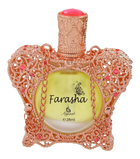 A close-up of an ornate perfume bottle with a rose gold lace-like design embellished with pink gemstones. The bottle cap is textured and also in rose gold, with a peach-colored top. It contains a yellow liquid, and the front of the bottle has the name "Farasha" printed in black, with a small butterfly motif above it, and "Ayyashi e 28ml" indicating the fragrance volume.