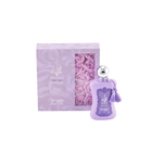 The image shows a bottle of "Fatima Velvet Love" extrait de parfum by Zimaya alongside its packaging. The perfume bottle is a soft lavender color with a silver spherical cap and is adorned with matching lavender tassels.   The accompanying box is also lavender with silver text and a clear window showcasing lavender rose petals inside, enhancing the luxurious and feminine presentation of the product.