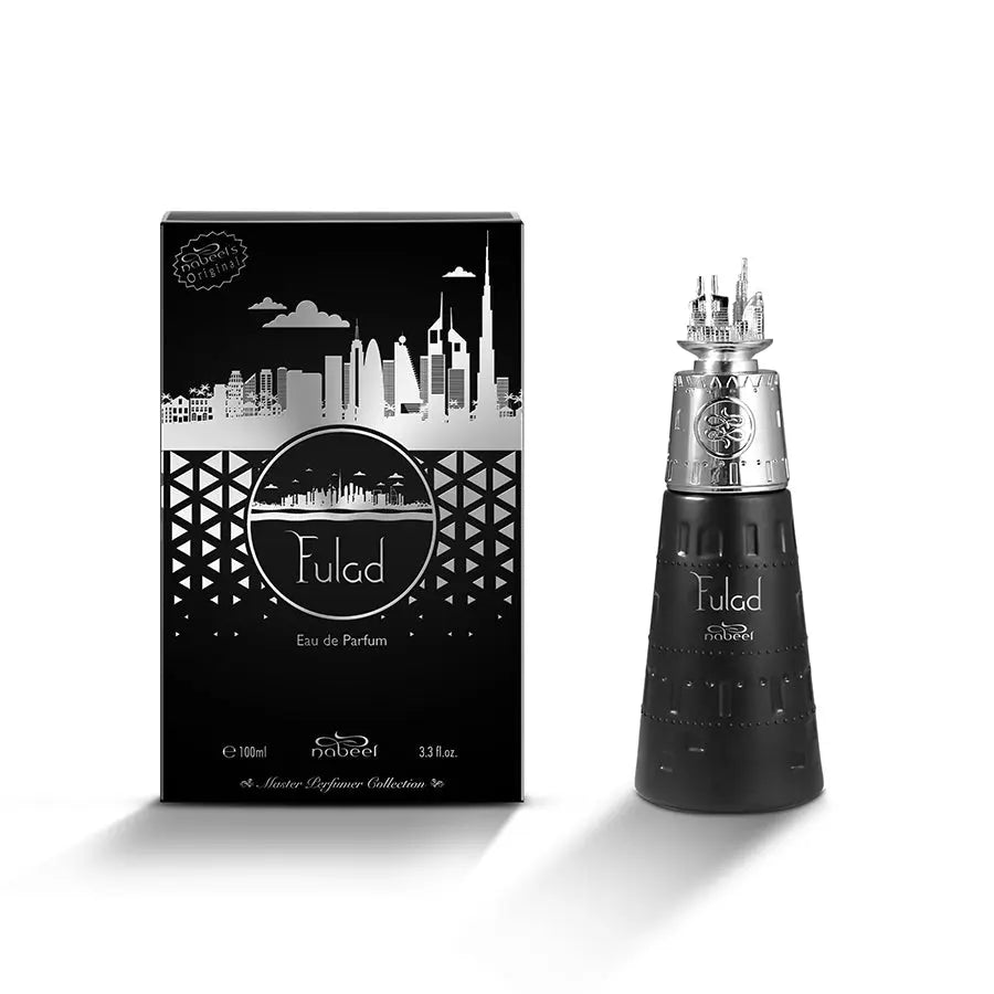 The image depicts a set comprising a black and silver perfume bottle named "Fulad" by Nabeel Perfumes and its accompanying box. The bottle has a conical, armor-like design with silver accents and a cap that resembles a detailed silver castle or cityscape. The box is black with a stylized silver cityscape design across it, a patterned border at the bottom, and the name "Fulad" within a circular frame above the brand name "nabeel" in white.