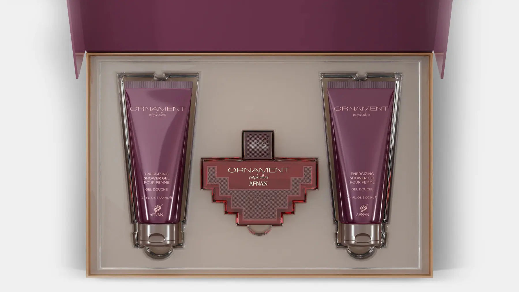 The image shows a gift set by Afnan Perfumes, "ORNAMENT purple allure". It features a perfume bottle and two tubes of shower gel, all in a coordinated deep purple color. The bottle has a unique, cross-shaped design with a red body and silver metalwork. The shower gels are labeled "ENERGIZING SHOWER GEL POUR FEMME" and are housed in sleek, metallic purple tubes.