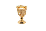 The image shows an ornate gold incense burner. The burner is designed with intricate floral patterns and delicate lattice work, giving it an elegant and luxurious appearance. It stands on a sturdy, decorative base and has a wide, open top to hold incense. The detailed craftsmanship and gold finish make this incense burner a sophisticated and decorative piece, suitable for enhancing home decor or as an elegant gift.