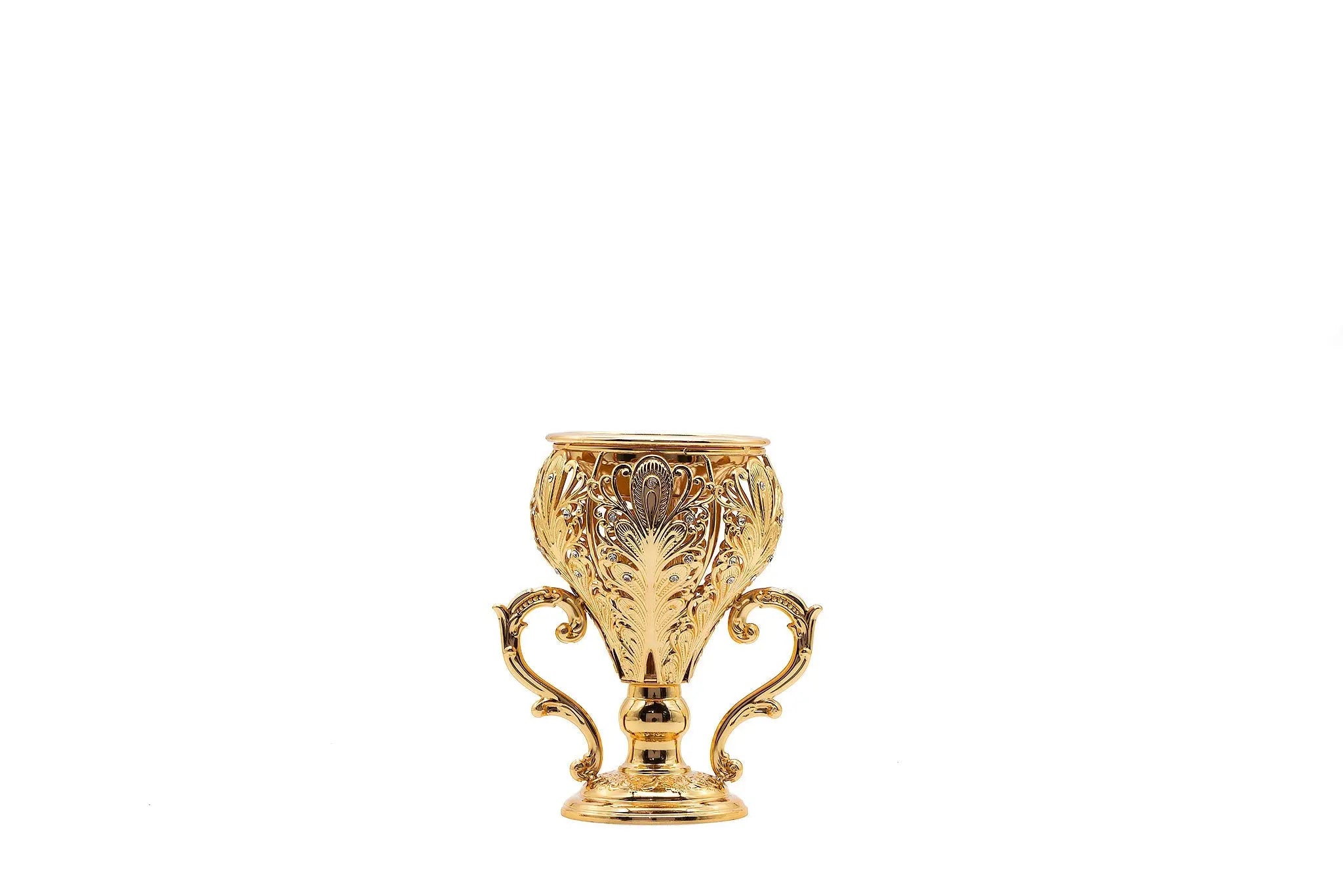 The image shows an ornate gold incense burner designed to resemble a small trophy. The burner features intricate engravings and floral patterns, with two elegantly curved handles on either side. It stands on a decorative base and has a wide, open top to hold incense. The detailed craftsmanship and gold finish give it a luxurious and regal appearance, making it a striking piece for home decor or a sophisticated gift.