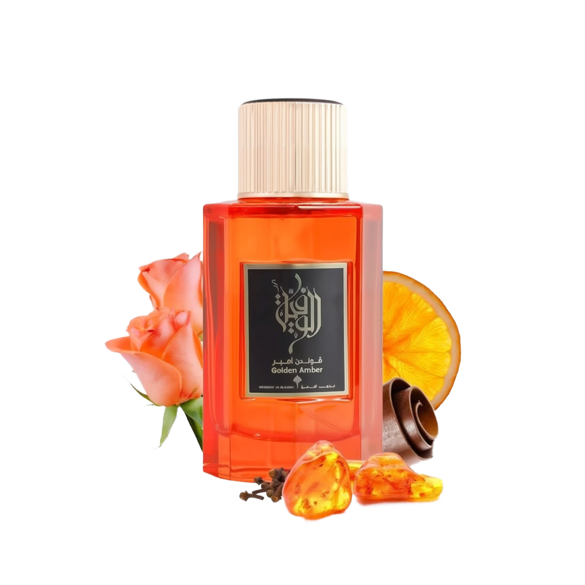 This is an image of a rectangular, transparent orange bottle of perfume labeled "Golden Amber" by Ibraheem Al Qurashi. The perfume bottle has a white cap and features black Arabic calligraphy on the label. Beside the bottle, there's a peach-colored rose, a slice of dried orange, a few cloves, and some pieces of amber resin, all placed against a white background. 