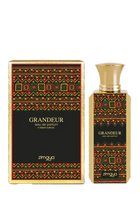 The image showcases "GRANDEUR" eau de parfum by Zimaya, along with its decorative box. The perfume bottle is rectangular with a bold geometric pattern in red, green, and gold, echoing traditional designs. A simple gold cap tops the bottle. The matching box mirrors the bottle's design with a black background, creating a striking contrast.