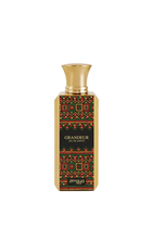 A photo of the GRANDEUR eau de parfum by Zimaya, featuring a tall rectangular bottle with a richly patterned label in red, green, and gold geometric shapes on a black background. The bottle has a polished gold cap, and the brand name "zimaya" is displayed at the bottom in white letters, with the perfume's name "GRANDEUR" and "eau de parfum" just above it in smaller white font.