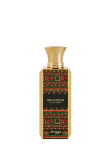 A photo of the GRANDEUR eau de parfum by Zimaya, featuring a tall rectangular bottle with a richly patterned label in red, green, and gold geometric shapes on a black background. The bottle has a polished gold cap, and the brand name "zimaya" is displayed at the bottom in white letters, with the perfume's name "GRANDEUR" and "eau de parfum" just above it in smaller white font.