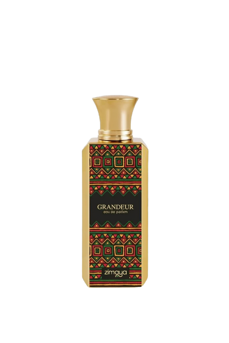 A photo of the GRANDEUR eau de parfum by Zimaya, featuring a tall rectangular bottle with a richly patterned label in red, green, and gold geometric shapes on a black background. The bottle has a polished gold cap, and the brand name "zimaya" is displayed at the bottom in white letters, with the perfume's name "GRANDEUR" and "eau de parfum" just above it in smaller white font.