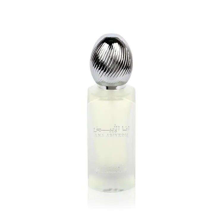  The image shows a frosted glass perfume bottle with a metallic, ribbed cap. The bottle has text in Arabic and English that reads "ANA ABIYEDH" indicating the fragrance name. The design is minimalist and modern, and the translucency of the bottle suggests a light or fresh scent, likely intended as a hair mist, as indicated by the product's volume labeled at the bottom "50ml."