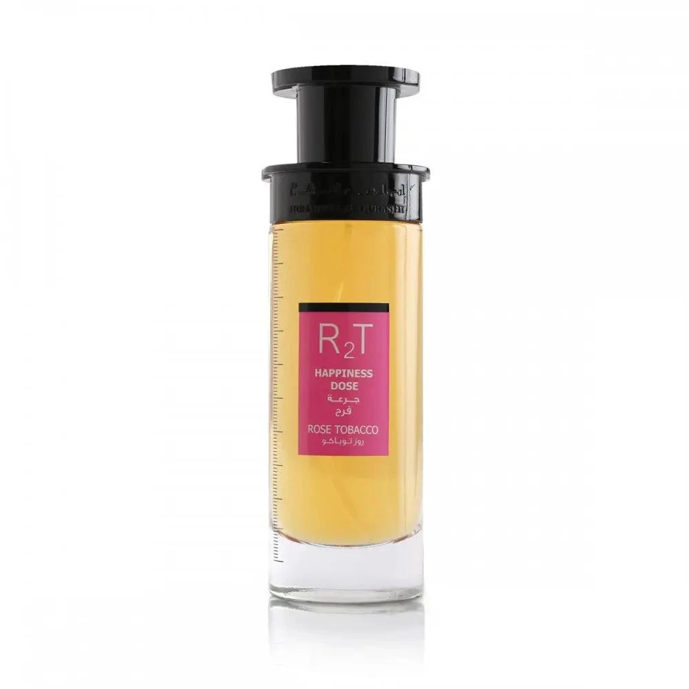 This is an image of a cylindrical clear perfume bottle with a black top and pump. The perfume has a yellow tint and features a pink label with the initials "RT" in large letters, the phrase "HAPPINESS DOSE" in smaller letters, both in English and Arabic, and "ROSE TOBACCO" underneath. The bottle is showcased against a plain white background, focusing on the simplicity and elegance of the design.