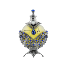 A luxurious perfume box and bottle from the brand Khadlaj, named Hareem Al Sultan Blue. The box is designed with intricate silver and blue patterns, featuring an ornate design that exudes elegance and sophistication. The perfume bottle is shaped like a teardrop and embellished with detailed silver and blue decorations.  The bottle has a prominent blue jewel at its center and is topped with a silver cap adorned with a blue gem.