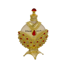The image displays an opulent perfume bottle with a white background. The body of the bottle is a pale, translucent yellow, topped with a bright red cap resembling a gemstone. The bottle is adorned with a golden overlay featuring intricate cut-out patterns and red gemstone accents. Arabic script is prominently displayed in the center, with smaller text below.