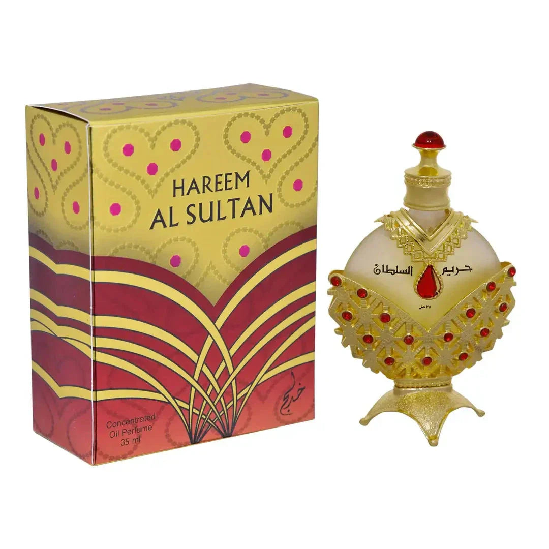 The image shows a richly decorated perfume box alongside a perfume bottle. The box has "HAREEM AL SULTAN" printed in bold, capital letters on a yellow and red patterned background, featuring heart and dot motifs, and a large abstract floral design in red and purple hues. Below the name, it states "Concentrated Oil Perfume 35 ml" in a smaller font.