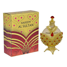 The image shows a richly decorated perfume box alongside a perfume bottle. The box has "HAREEM AL SULTAN" printed in bold, capital letters on a yellow and red patterned background, featuring heart and dot motifs, and a large abstract floral design in red and purple hues. Below the name, it states "Concentrated Oil Perfume 35 ml" in a smaller font.