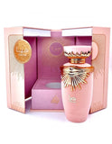 The image shows a pink and gold perfume bottle placed in front of its packaging. The packaging consists of a pink box with gold detailing and the brand name prominently displayed. The bottle itself has a matte pink finish with a rose gold cap featuring wing-like designs and a central emblem, matching the box's aesthetics. The box is open, suggesting the product is ready for display or use. Visible on the box are the words "Eau de Parfum" and possibly the name of the fragrance. 
