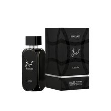 The image shows a black bottle of perfume from Lattafa with the name "Hayaati" written in both Arabic and English on the front. The bottle has a sleek, rectangular design with rounded edges and a silver ring around the neck. The packaging box, also black,